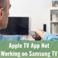 Male turning on TV with remote