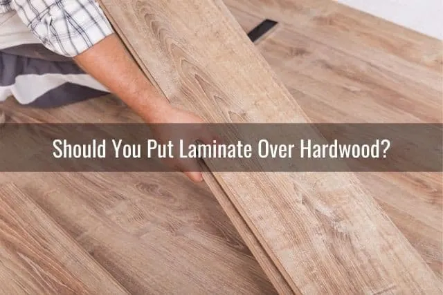 Hand laying down a laminate floor plank