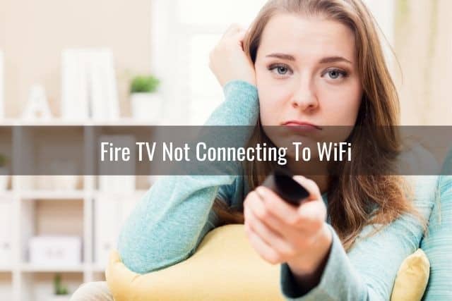 Female looking disappointed while holding TV remote