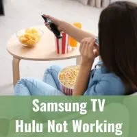 Female sitting on sofa eating popcorn and using remote to change TV programming
