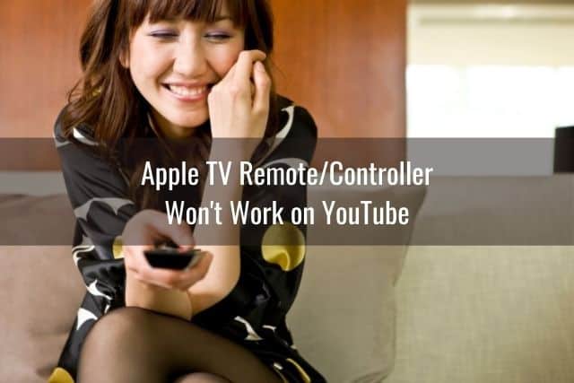Smiling female with TV remote in hand