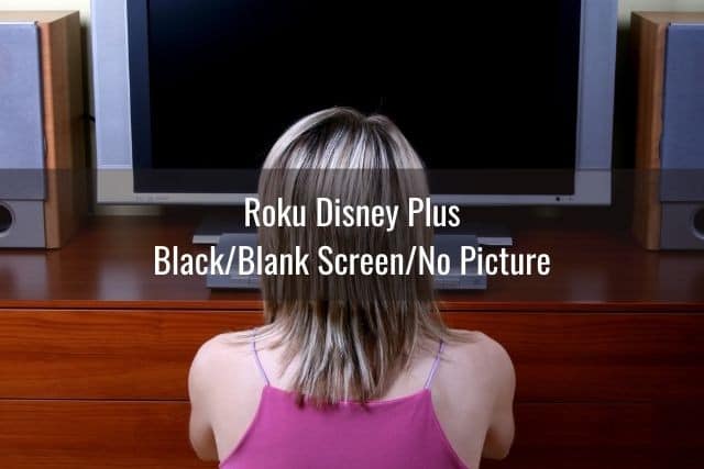 Female teenager looking at black TV screen