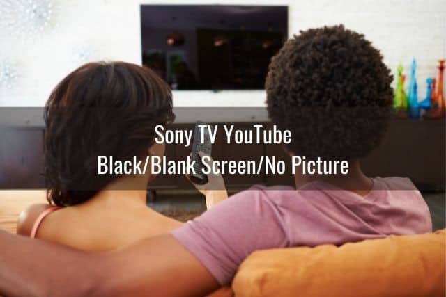 Black male female couple about to turn on TV