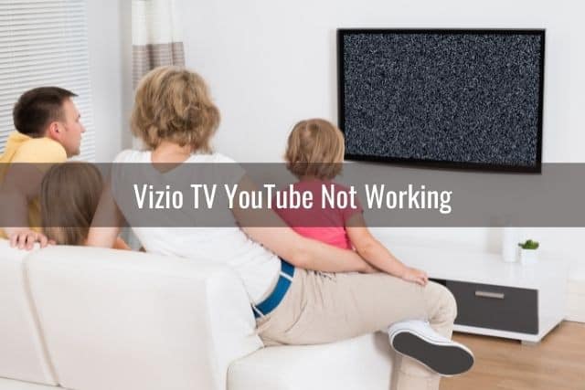 Family of four watching TV that has static