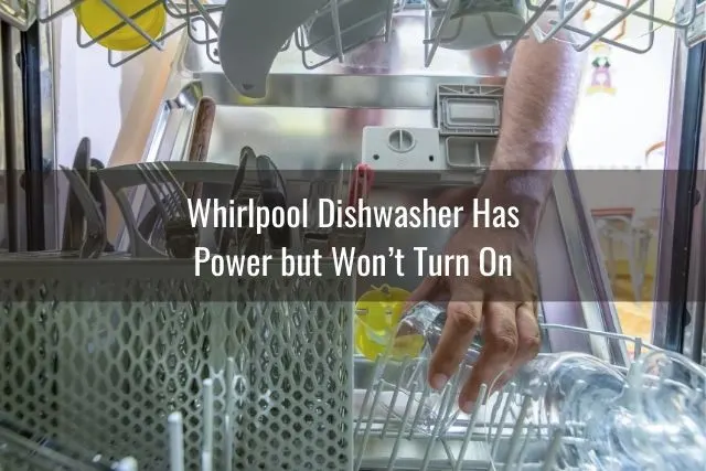 Hand putting dishes in dishwasher