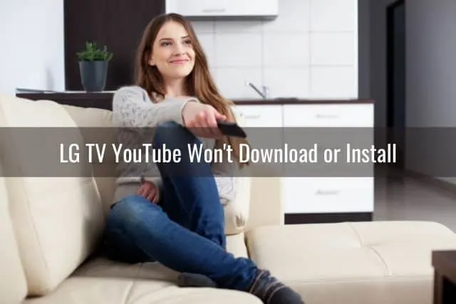 Female smiling and watching TV with remote in hand