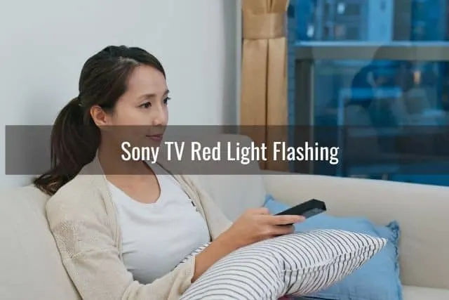 Female using remote to change channels