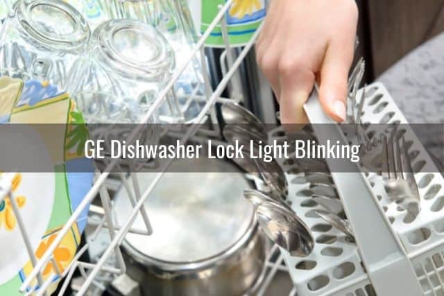 Hand moving dishes around inside dishwasher