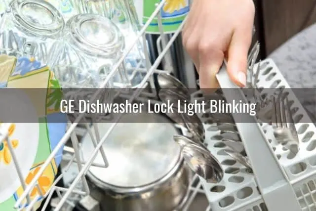Hand moving dishes around inside dishwasher