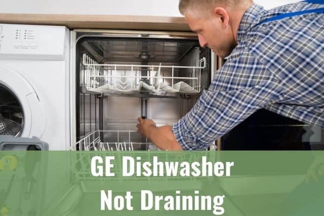 Repairman fixing dishwasher