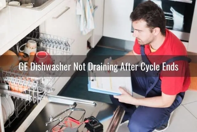 Repairman troubleshooting broken dishwasher