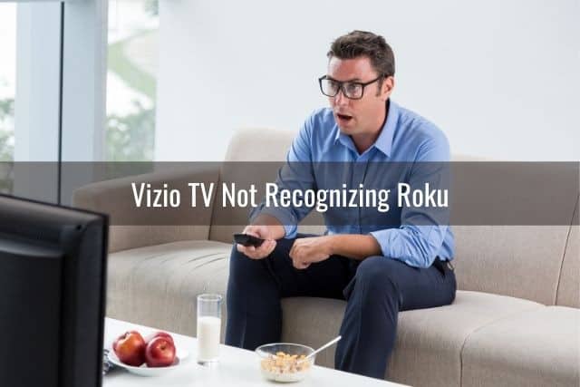 Male in shock while holding TV remote and watching Tv