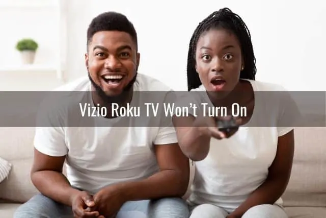 Male and female couple in shock while watching Tv