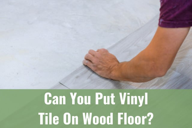 Worker installing new vinyl tile