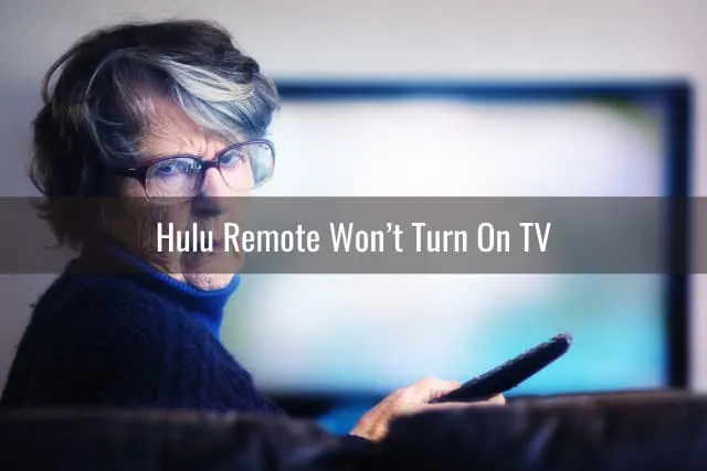 confused old woman while holding a remote