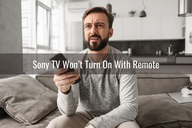 Disappointed man holding a remote