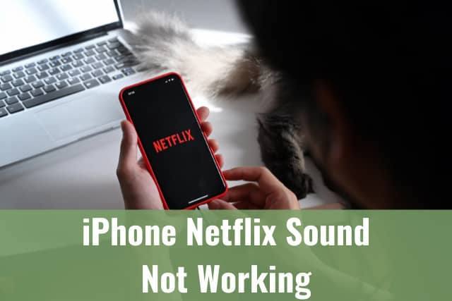 woman holding iphone while watching netflix