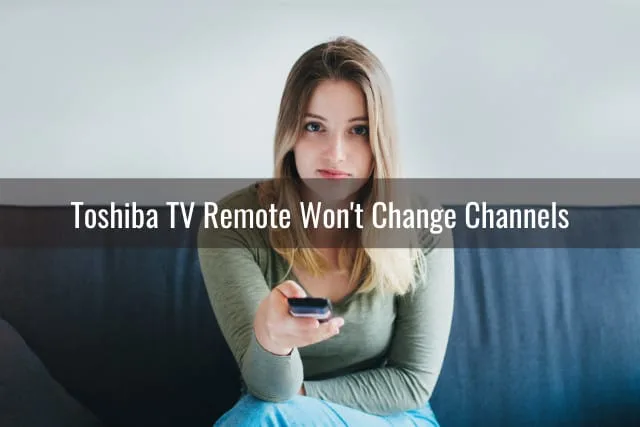 Confused woman while holding a remote