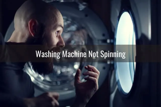 Man looking at the washing machine