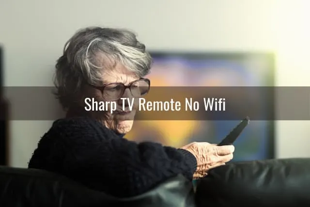 Confused old woman while holding a remote