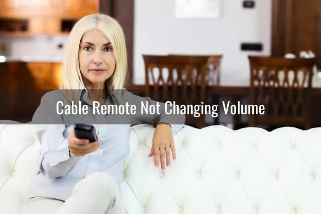 Woman holding a remote while watching tv