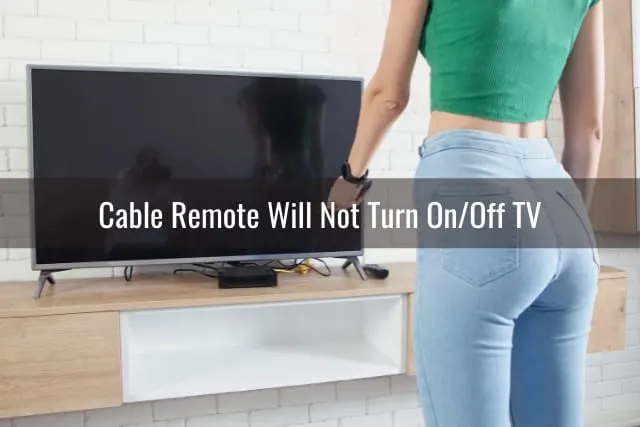 Woman standing holding a remote while pointing at tv