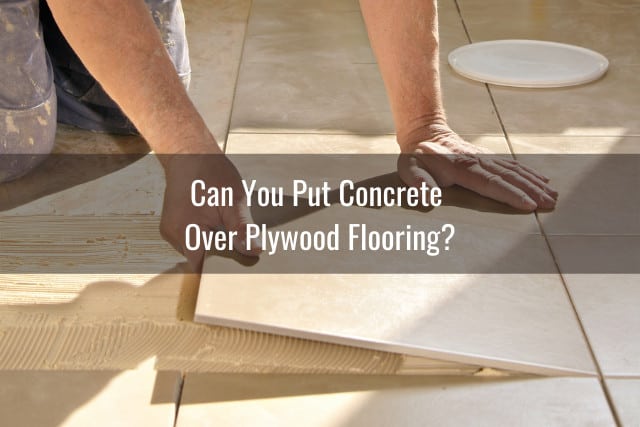 Man putting a concrete tile over a plywood