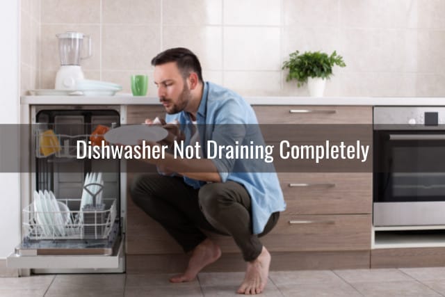 Man holding a plate in the diswasher