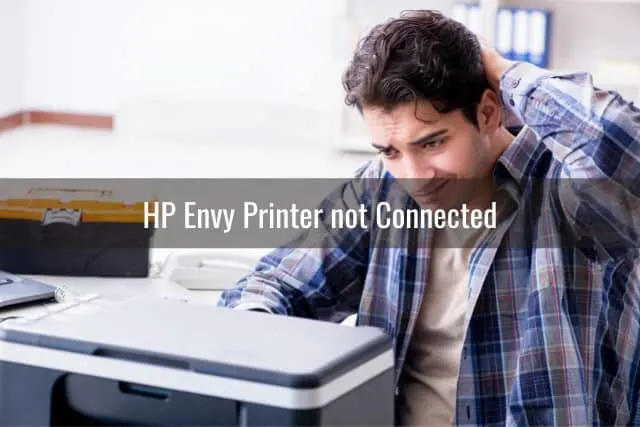 frustrated man while looking at the printer