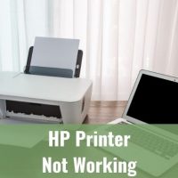 Laptop and printer on wood table