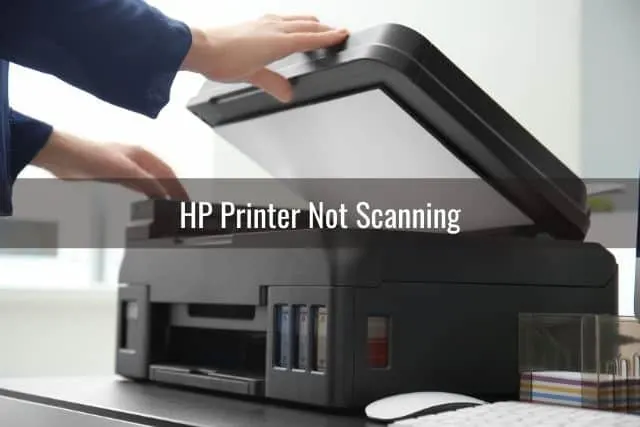 Person scanning documents on printer