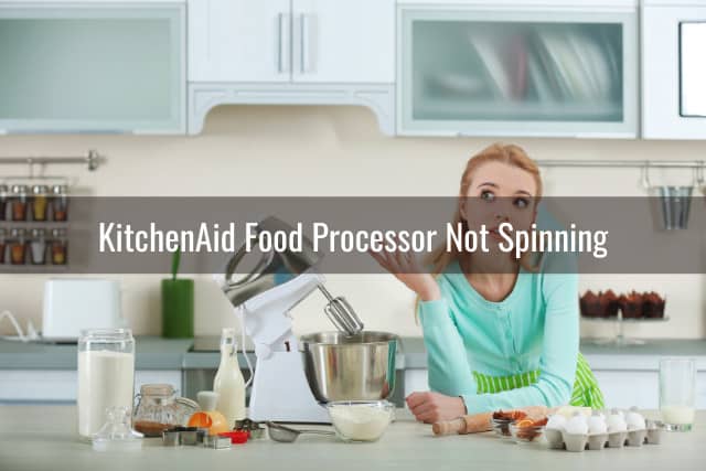 Woman thinking while behind the food processor