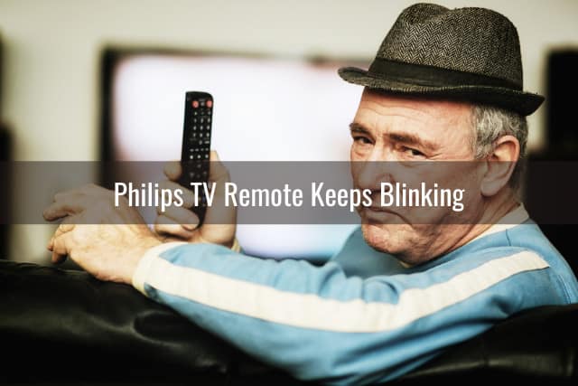 confused man while holding a remote