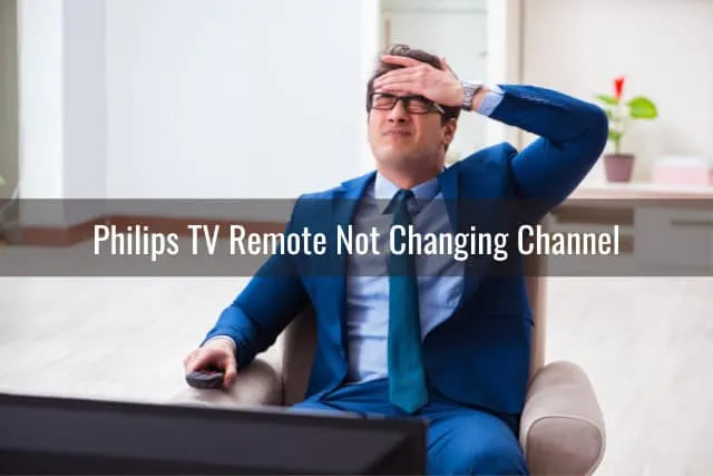 Frustrated man while holding a remote