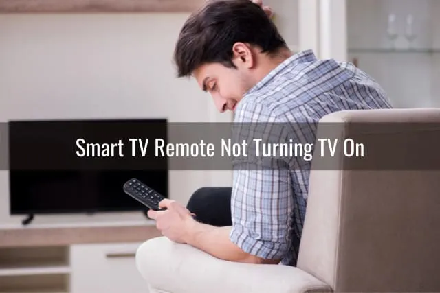 Man holding a remote while looking at it