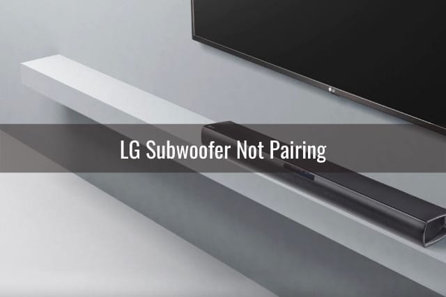 Black Subwoofer with flatscreen TV and soundbar behind