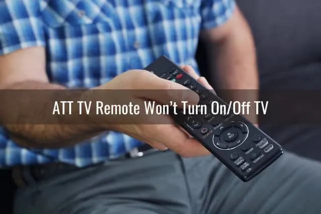 Man holding a remote while pointing in the TV