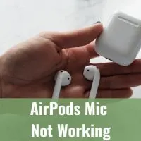 holding an AirPods