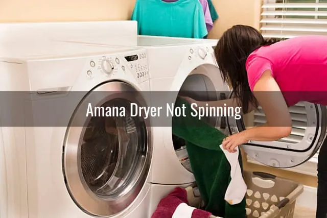 Woman putting clothes in dryer