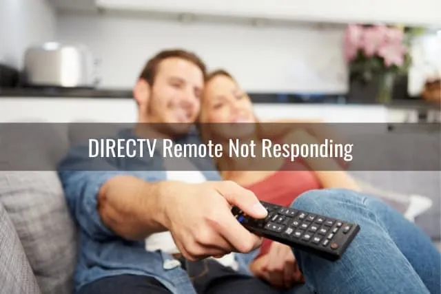 Couple watching TV while holding a remote