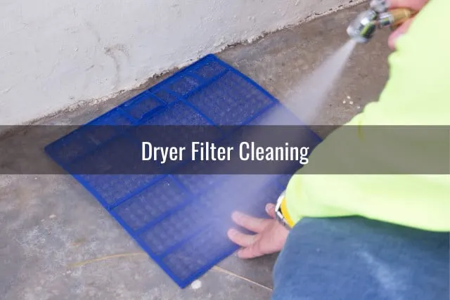 Man cleaning the dryer's filter