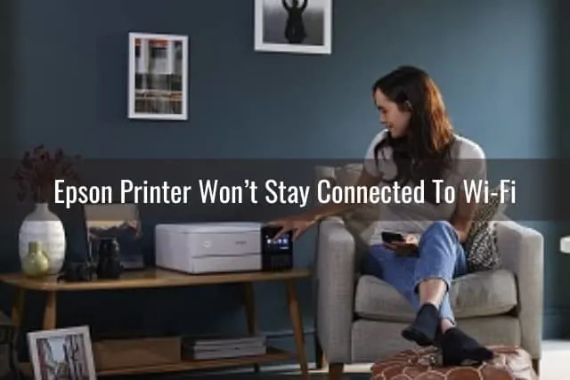Woman sitting on the floor with printer on the desk