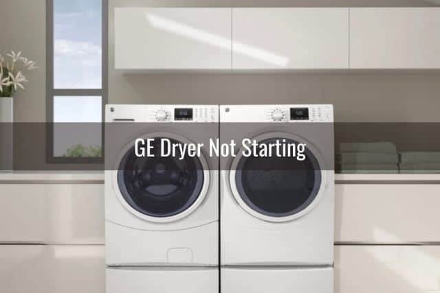 White dryer and washing machine in laundry room