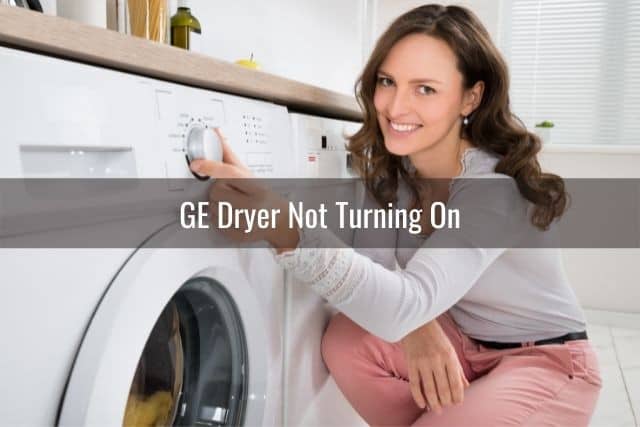 Woman turning dryer machine knob control