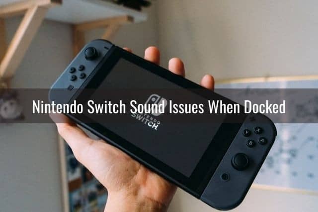 Black Nintendo Switch in hand