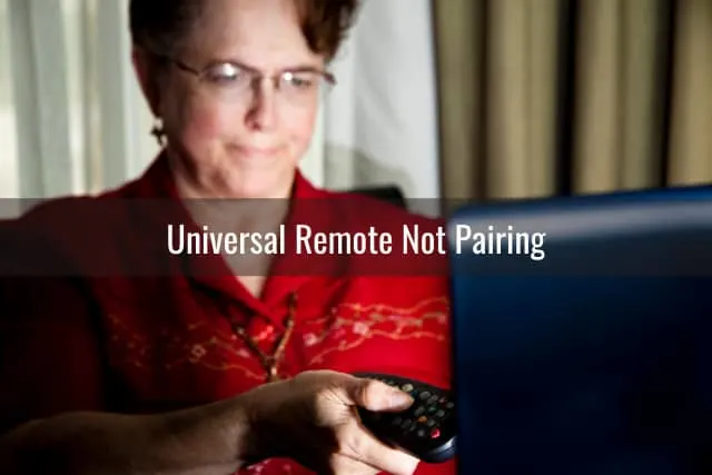 Woman holding a remote while pointing in the TV