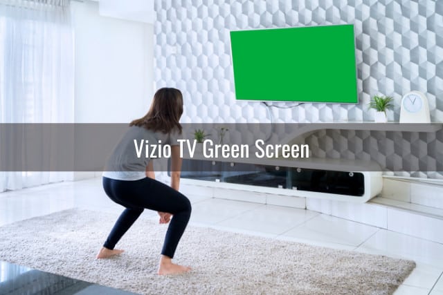 Frustrated woman looking at the green screen tv