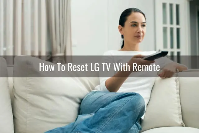 woman sitting on the couch while holding a remote