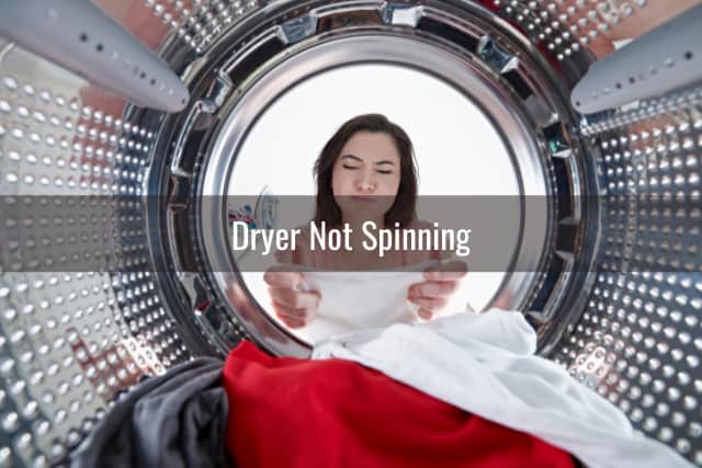 Woman checking the clothes inside the dryer