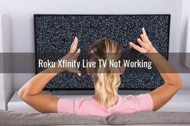 Frustrated woman with hands up staring at static TV screen